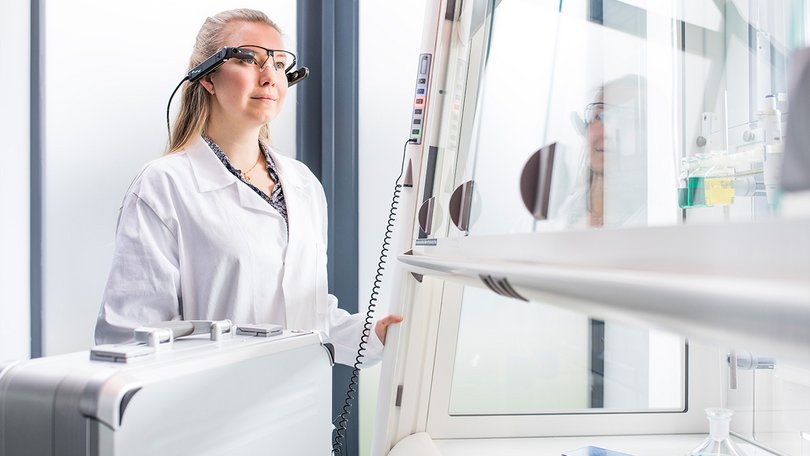 Woman in front of a fume hood