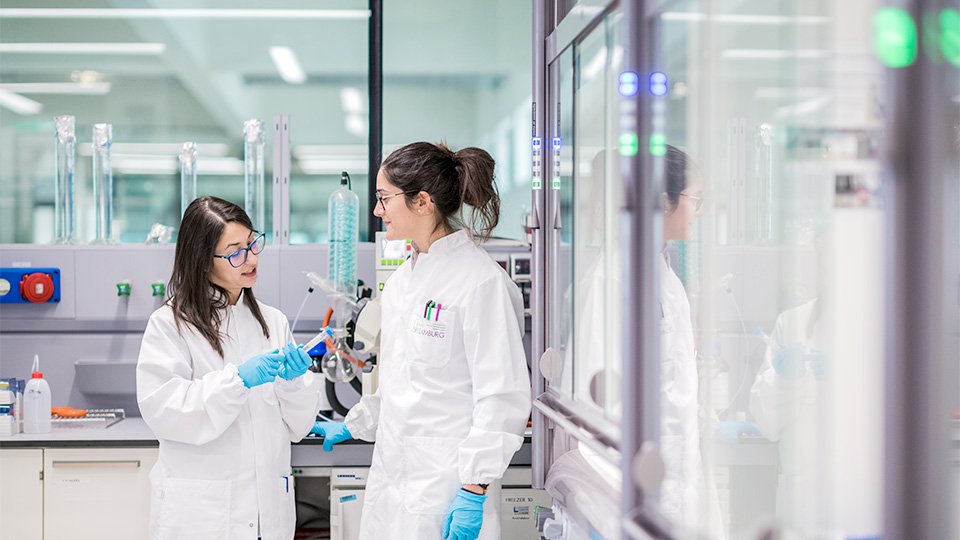 Two women standing in a laboratory